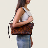 Model wearing the Blake Large Clutch in cheetah print calf hair on the shoulder