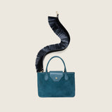 Fringe Shoulder Strap in black nappa leather attached to a bottle green suede tote