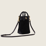 Lola Mini Shopper in black suede with its shoulder strap attached, three-quarter view