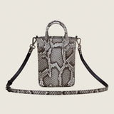 Lola Mini Shopper in Burmese python with its shoulder strap attached
