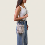 Model wearing the Lola Mini Shopper in Burmese python crossbody