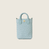 Front view of the Lola Mini Shopper in light blue ostrich with gold star logo