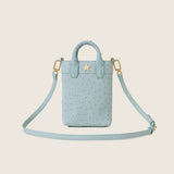 Lola Mini Shopper in light blue ostrich with star logo and its shoulder strap attached