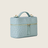 Mia Vanity Bag in light blue ostrich with gold zipper, three-quarter view