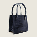 Molly Mini Book Tote in navy alligator, three-quarter view