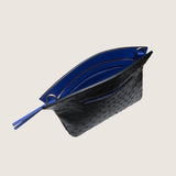 Taylor Mini Clutch in black ostrich unzipped to show the bright blue interior lining