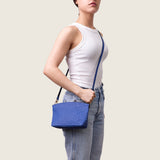 Model wearing the Taylor Mini Clutch in blue ostrich crossbody