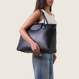 Model wearing the Alessia Large Tote in black nappa leather on the shoulder