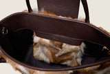 Interior of the Alessia Large Tote showing the dark lining and the fur cross-body pouch inside