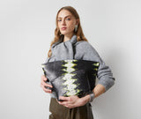 Model holding the Blake Large Clutch in black and lime python-embossed leather in front of her
