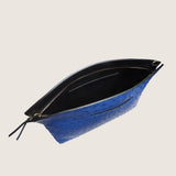Blake Large Clutch in blue ostrich unzipped to show the black interior lining