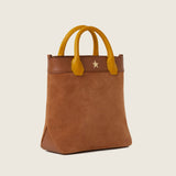Kelly Medium Shopper in tan suede with mustard leather handles and gold star detail, three-quarter view