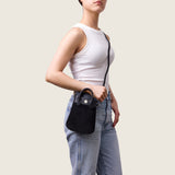Model wearing the Lola Mini Shopper in black suede crossbody