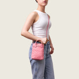 Model wearing the Lola Mini Shopper in pink ostrich crossbody