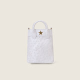 Front view of the Lola Mini Shopper in white ostrich with gold star logo