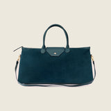 Maverick Weekender in bottle green suede with its shoulder strap attached