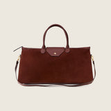 Maverick Weekender in cognac suede with its shoulder strap attached
