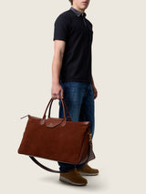 Man carrying the Maverick Weekender in cognac suede