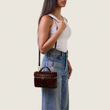 Model wearing the Mia Vanity Bag in cheetah print calf hair on the shoulder