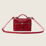Mia Vanity Bag in cherry red alligator with its shoulder strap attached